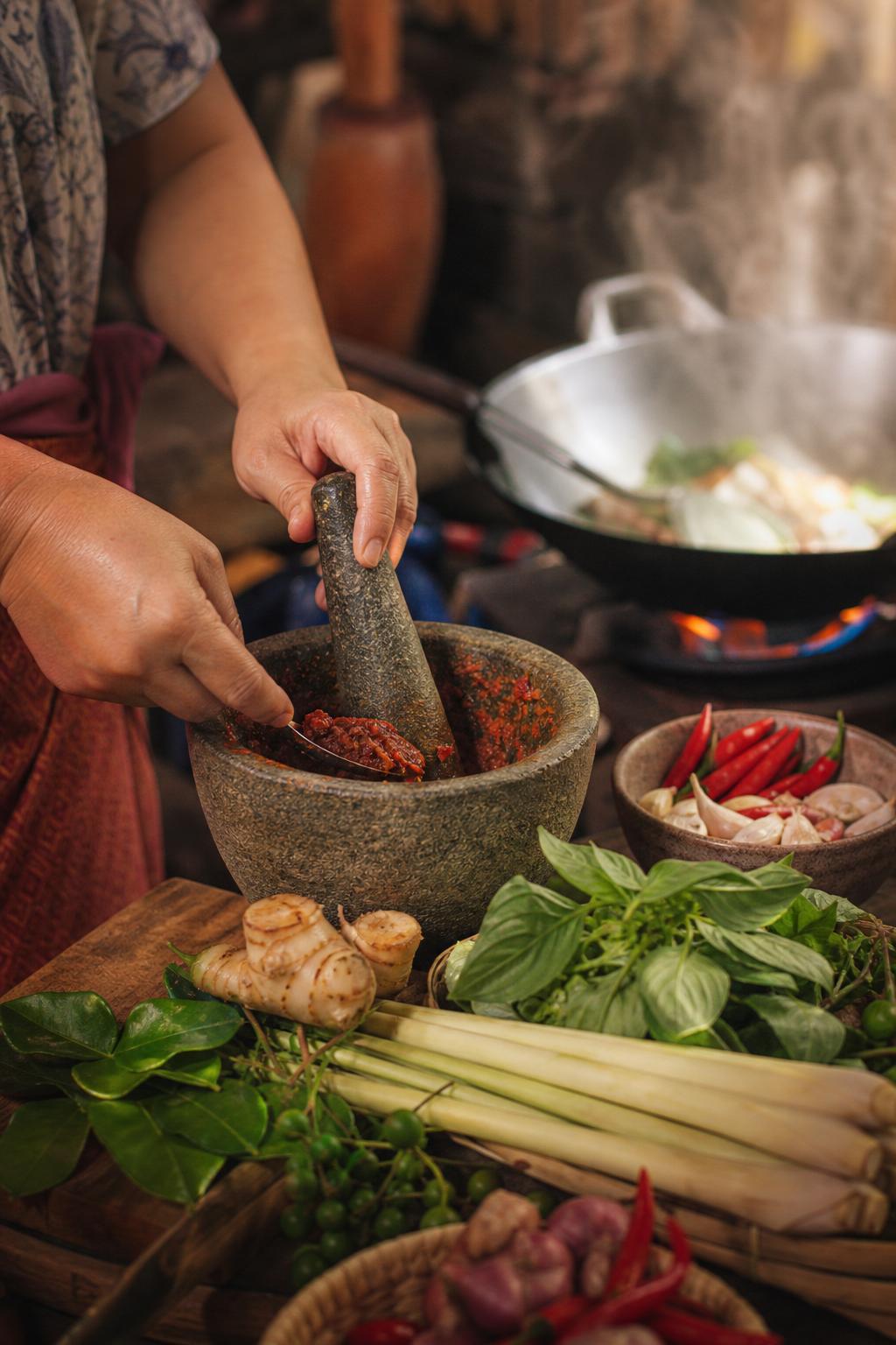 Preparing traditional Thai recipes with fresh herbs and spices